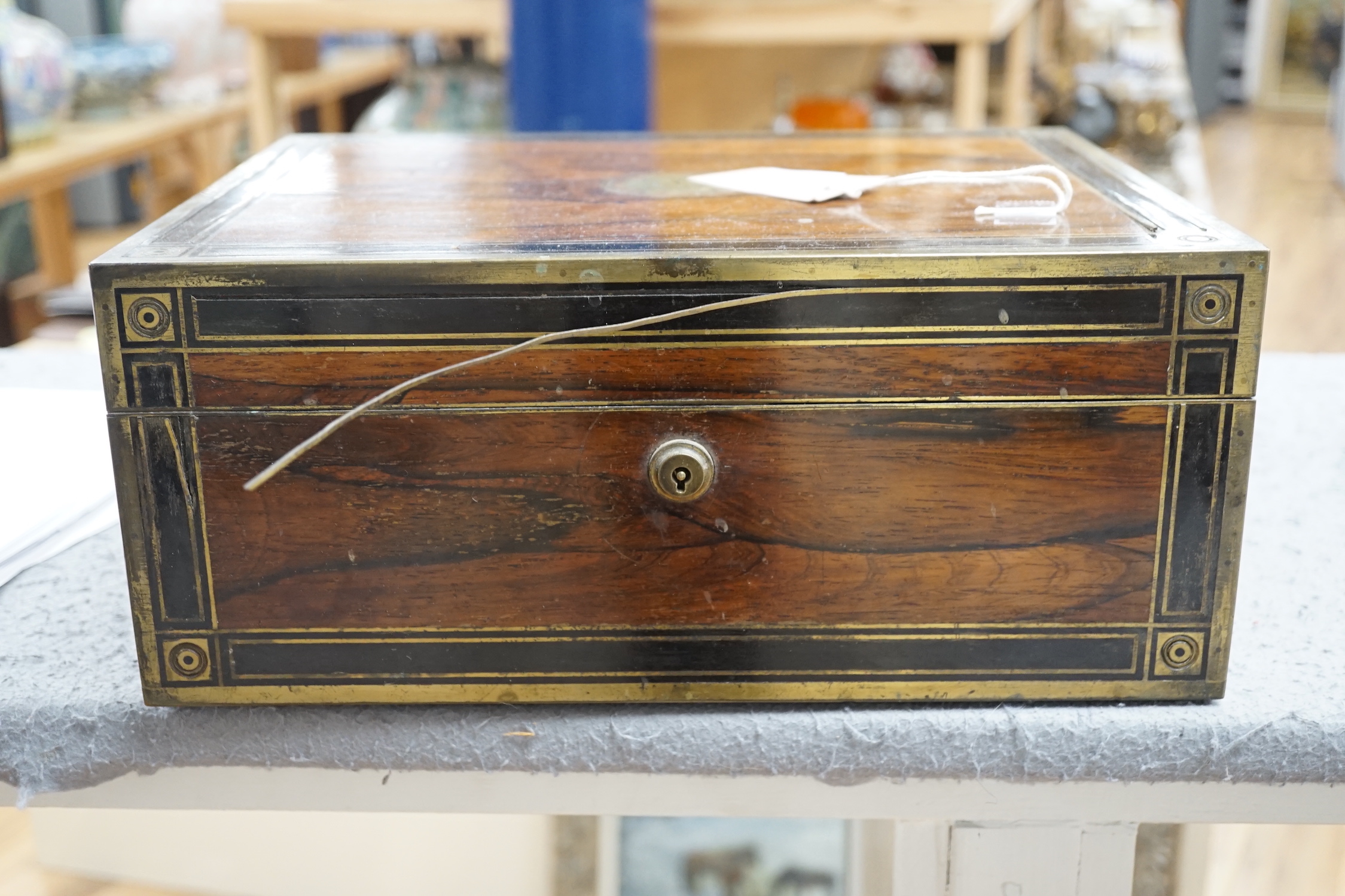 A George IV brass mounted rosewood travelling toilet box, with eleven silver mounted glass toilet jars etc, John & Archibald Douglas, London, 1822, with engraved monograms, four caps unmarked, box 34.1cm.